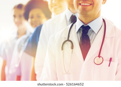 Health Care, Profession, People And Medicine Concept - Close Up Of Happy Doctors With Stethoscope At Hospital