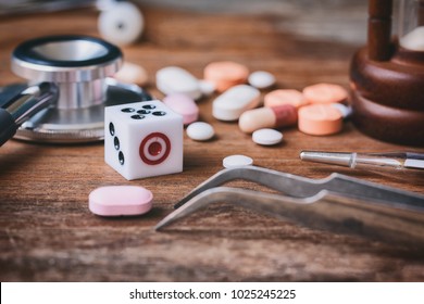 Health Care And Risk Of Death From Accidental Overdose Concept. Pills And Dice On Wooden Background
