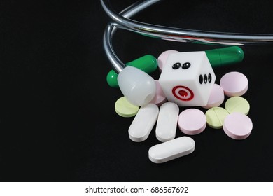 Health Care And The Risk Of Death From Accidental Overdose, Soft Focus Dice And Capsule Stethoscope On The Dark Table.