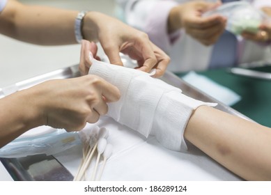 Health care series : Closeup of hands of nurse dressing wound for patient's hand with burn injury