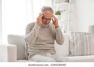 health care, stress, old age and people concept - senior man suffering from headache at home - Shutterstock ID 1244330440