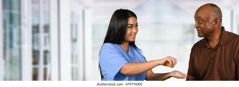 Health care worker helping an elderly patient take his pills - Powered by Shutterstock