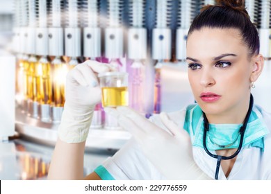 Health Care Worker Holding A Urine Sample In The Front Of The Medical Vials