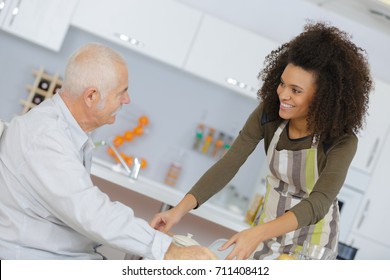 health care worker serving a meal to an elderly patient - Powered by Shutterstock