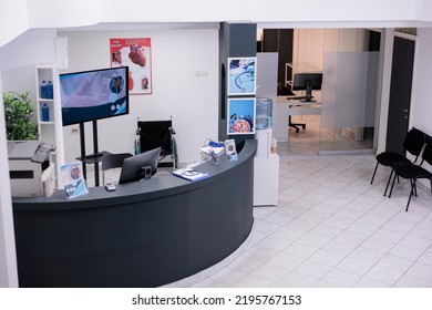 Health Center Reception Desk For Appointments And Checkup Visits In Facility Lobby, Hospital Registration Counter With Medical Reports And Consultations Forms. Healthcare Clinic Waiting Area.