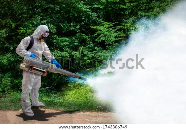 Health center staff spraying the smoke to get rid\
of mosquitoes at forest for stop spreading infections dengue fever\
and malaria