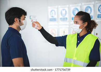 Health check factory personnel using medical digital temperature thermometer to check warehouse staff, measures for the prevention of communicable diseases for health - Powered by Shutterstock