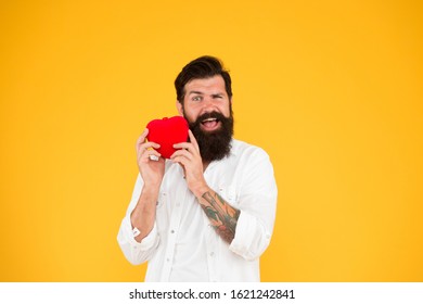 Health Check helps understand risk factors for heart disease and estimate how likely have attack or stroke next years. Man bearded hipster hold red heart toy. Medicine concept. Listen to your heart.