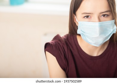 Health Check In A Medical Clinic, Teenager Girl In A Doctor's Office In A Protective Mask