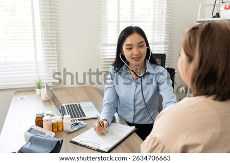 Health Checkup and Patient Assessment. A nurse using a stethoscope to examine a patient during a routine checkup.