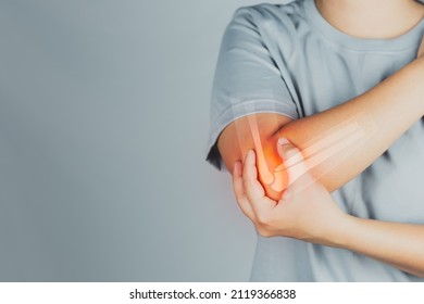 Health concept, person with elbow pain, woman holding hands on elbow with pain, virtual bone image on elbow - Shutterstock ID 2119366838
