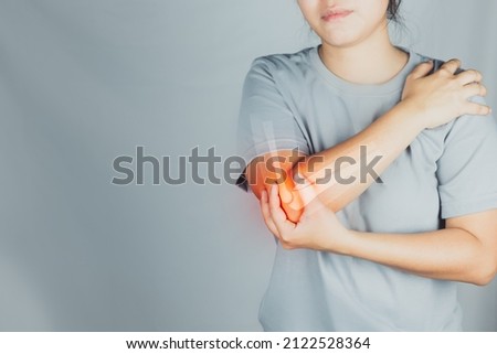 Health concept, person with elbow pain, woman holding hands on elbow with pain, virtual bone image on elbow