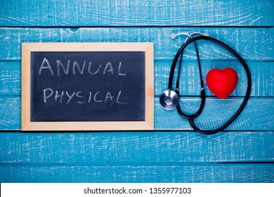 Health Concept Showing A Heart And Stethoscope With A Chalkboard Reading Annual Physical