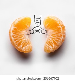 A Health Concept Of Unhealthy Human Lungs Of A Smoker With Lung Cancer In Dark Shadows, Made Of Mandarin Segments.