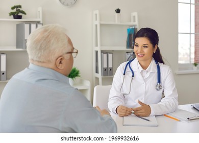 Health consultation at clinic or hospital. Smiling nurse or general practitioner talking to mature man. Happy young female doctor listening to senior patient during medical interview in her office