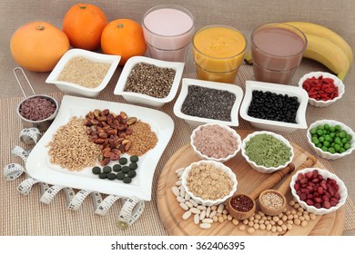 Health Food For Body Builders With Supplement Powders, Vitamin Tablets, Pulses, Nuts, Vegetables, Fruit And Smoothie Juice Shakes With Tape Measure. 