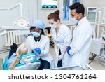Health and healthcare. A multinational group of dentists examines x-rays in the presence of a patient. Practice at a medical university.