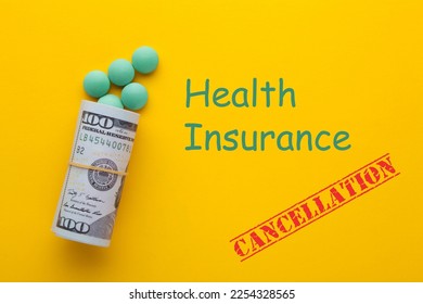 Health insurance cancellation text with medical pills with rolled 100 dollar banknotes on a yellow background. Health and medicine care concept. - Shutterstock ID 2254328565