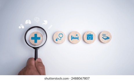 Health insurance concept, Health and access to welfare health concept, Human hands hold a magnifying glass and focus on the plus sign and healthcare medical icon on white background.