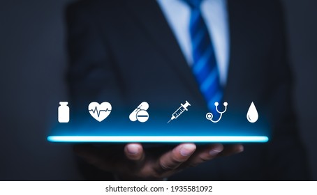 Health Insurance Concept, Businessman Holding Healthcare Medical Icon