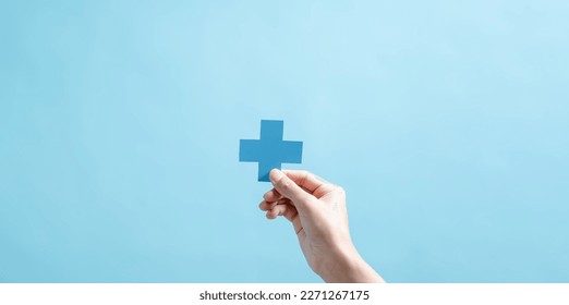 Health insurance concept. people hands holding plus and healthcare medical icon, health and access to welfare health concept. - Shutterstock ID 2271267175