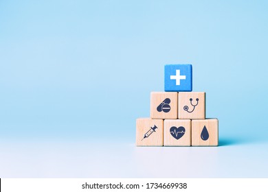 Health Insurance Concept, Wooden Blocks With Healthcare Medical Icons On Blue Background, Copy Space