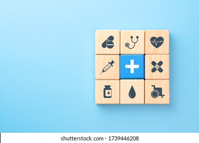 Health Insurance Concept, Wooden Blocks With Healthcare Medical Icons On Blue Background, Copy Space