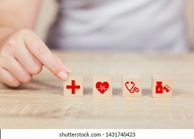 Health Insurance Concept,hand arranging wood block stacking with icon healthcare medical.
