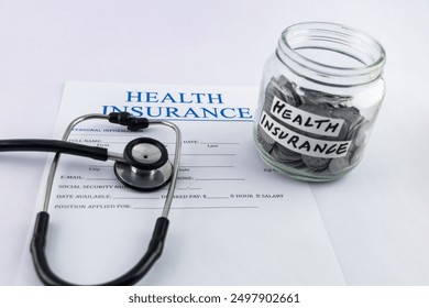 Health insurance form with the stethoscope and a lot of coins jar. - Powered by Shutterstock