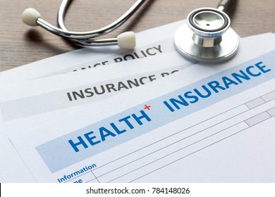 Health insurance form with stethoscope in top view