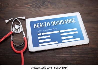 Health Insurance Online Claim  Form On Screen Tablet Pc, Health Concept. Information Technology And Mobile Application In Healthcare/medical.