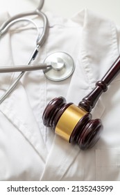 Health And Law. Medical Malpractice, Personal Injury Lawyer. Judge Gavel And Stethoscope On Doctor Coat, Top View
