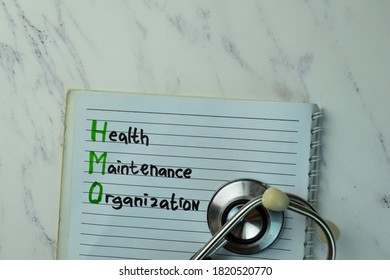 Health Maintenance Organization Write On A Book Isolated On Office Desk.