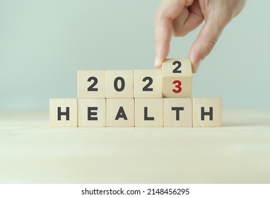 Health Management And Trend Concept In 2023. Medical Healthcare Business And Personal Healthcare. Hand Flips Wooden Cubes 2022 To 2023 With Text 