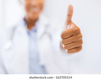 Health And Medicine Concept - Close Up Of Female Doctor Hand Showing Thumbs Up