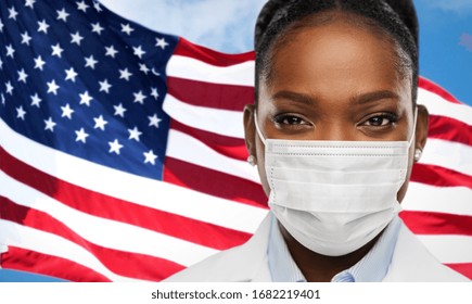 Health, Medicine And Pandemic Concept - Close Up Of African American Female Doctor Or Scientist In Protective Medical Mask Over Flag Background