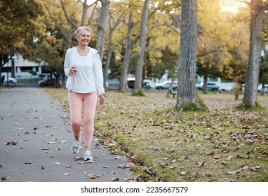 Health, nature and senior woman on walk in the morning for exercise, wellness and fitness in park. Healthy, outdoor and elderly lady in retirement from Australia walking in garden for cardio workout. - Powered by Shutterstock