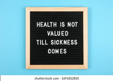 Health is not valued till sickness comes. Motivational quote on black letter board on blue background. Concept Health Care and Medicine, inspirational quote of the day.