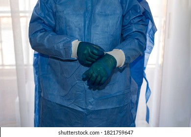 Health Nurse Puts On A Suit, Gloves, A Mask, A Hat, To Cure The Sick