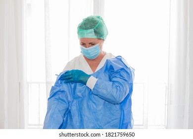 Health Nurse Puts On A Suit, Gloves, A Mask, A Hat, To Cure The Sick