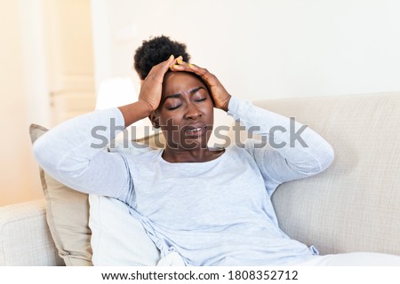 Health And Pain. Stressed Exhausted Young black Woman Having Strong Tension Headache. Closeup Portrait Of Beautiful Sick Girl Suffering From Head Migraine, Feeling Pressure And Stress.