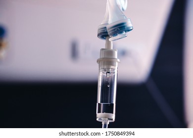 Health Patient Concept, Saline Solution In Tube Of Bottle In Patient Hospital Room. Saline Is Mixture Of Sodium Chloride In Water And Has A Number Of Uses In Medicine