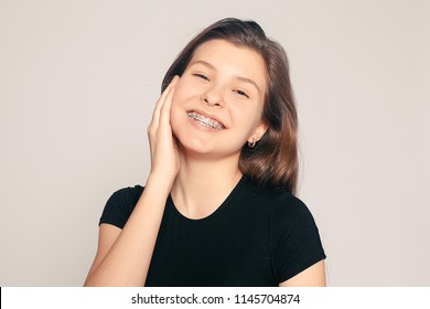 health, people, dentist and lifestyle concept - Portrait of teen girl showing dental braces. candid portrait of a girl wearing braces, with hair motion. laughing girl wearing braces, cheerful portrait