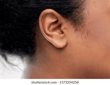 Health, People And Hearing Concept - Close Up Of Young African American Woman Ear