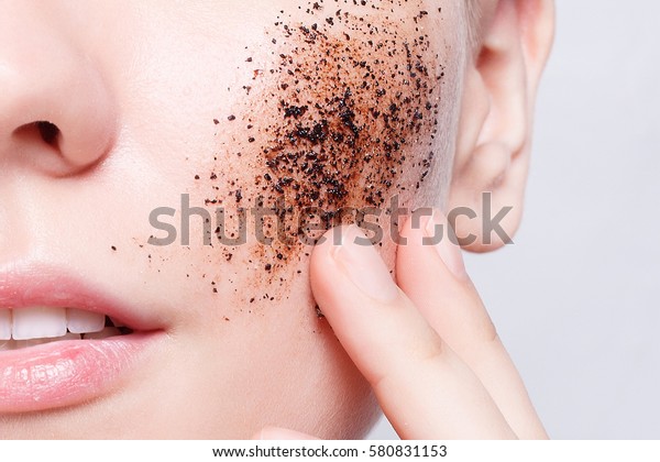 health, people, Skin Care, youth and beauty\
concept - Smiling woman with short hair, bald cleans the skin\
coffee skrub, studio shot, close-up portrait. Clean Fresh Skin\
close up. Spa Woman\
Smiling