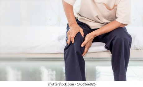 Health Problem Concept; Old Woman Suffering From Knee Pain At Home.