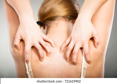 Health problem, skin diseases. Young woman scratching her itchy back with allergy rash