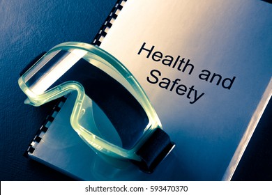 Health And Safety Document With Goggles In Toning