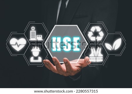 Health safety environment, HSE education industry Concept, Man hand holding health safety environment icon on virtual screen.