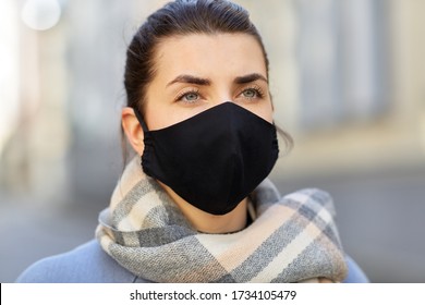 Health, Safety And Pandemic Concept - Young Woman Wearing Black Face Protective Reusable Barrier Mask Outdoors